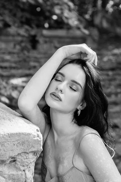 Beautiful girl with clean and pigmented skin on the nature on the lake