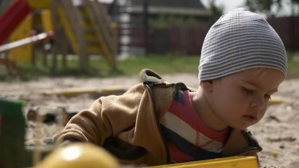 Serious Cute Child Plays Alone Broken Toy Sandbox One Little — Stock Video