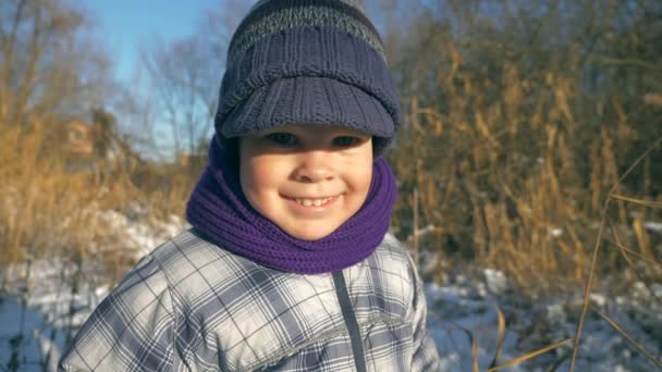 Criança Feliz Sorri Câmera Garoto Bonito Roupas Quentes Inverno Livre — Vídeo de Stock