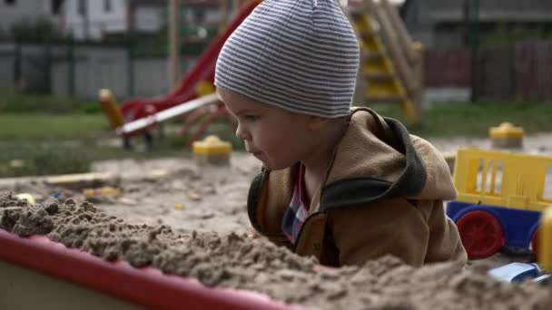 Serious Kid Plays Sandbox Children Playground Toys Boy Looking Back — Stock Video