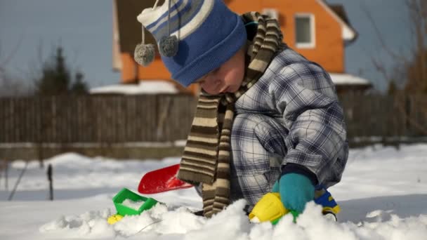 Little Boy Plays Toy Trucks Snow Backyard Garden Cold Weather — Stock Video