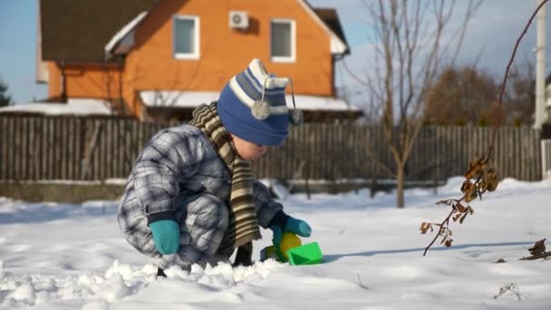 Little Boy Plays Toy Trucks Snow Backyard Garden Cold Weather — Stock Video
