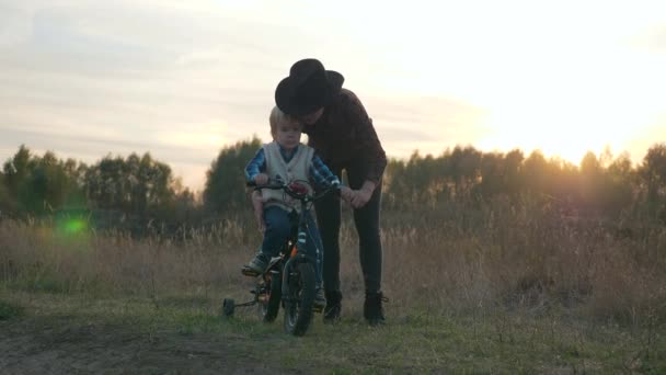 母亲第一次教儿子骑自行车在乡间土路上 慢动作 — 图库视频影像