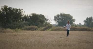 Man and Boy, Oyuncak Uçakla Sahada Oynuyor. Baba ve Çocuk Doğa 4K 10-bit 'te Birlikte Zaman Geçiriyorlar