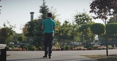 Teenage Boy Walk in Park 4K 10-bit 60fps Slow motion