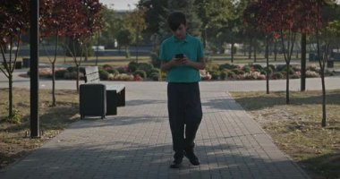 Teenage Boy Walk in Park 4K 10-bit 60fps Slow motion