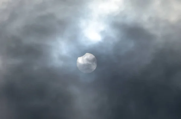 Partial Solar Eclipse in the Cloudy sky.