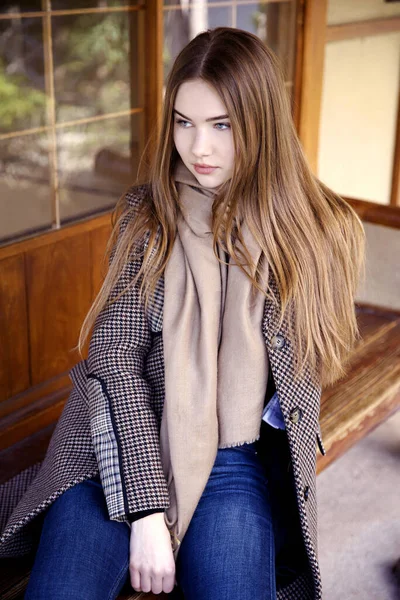 Baharda bahçede poz veren uzun saçlı genç kız.