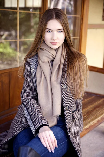 Baharda bahçede poz veren uzun saçlı genç kız.