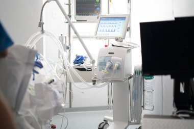 Modern medical ventilator assisting a patient's breathing in a hospital icu setting