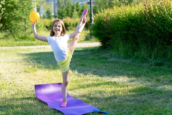 Little girl goes in for sports in the park.