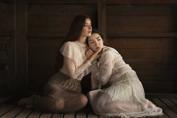 Two Brunettes Sitting Tender Embrace Wooden Floor Cabin — Stock Photo, Image