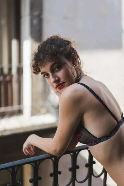 Sensual woman in lingerie standing on balcony — Stock Photo, Image