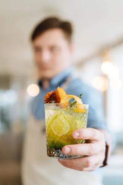 Close Cut Glass Filled Exotic Nordic Cocktail Garnished Flowers Hand — Stock Photo, Image