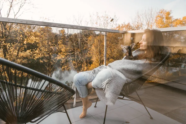 Shot Glass Window Woman Sitting Balcony Dog Hands Golden Trees — Stock Photo, Image