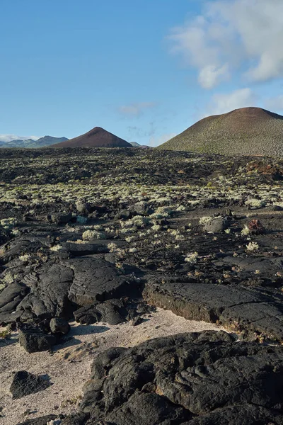 Svart Strukturerad Grov Klippa Med Berg Bakgrunden — Stockfoto