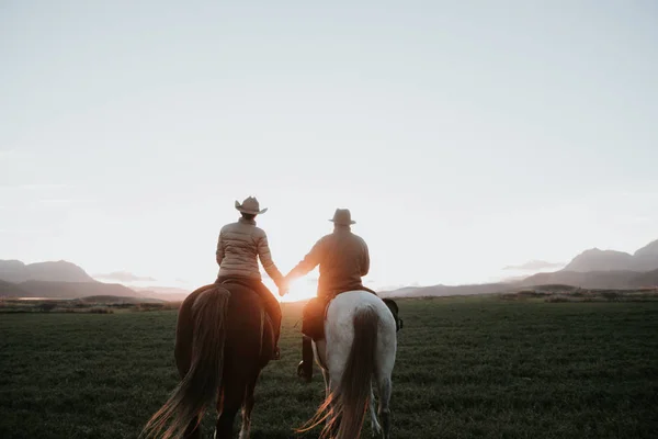 Back View Man Woman Riding Horses Holding Hands Sunset Sky — Stock Photo, Image