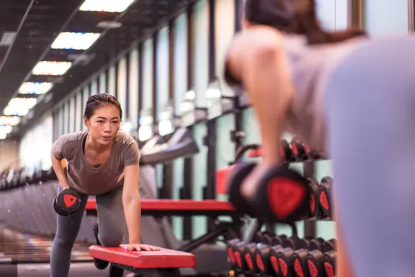 Concentrated Young Asian Sportswoman Active Wear Doing Dumbbell Row Horizontal — Stock Photo, Image