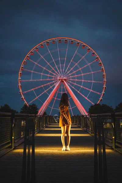 背景に輝くライトアップされた桟橋上の匿名の女性観光客モントリオールの観覧車 — ストック写真