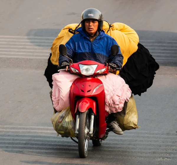  Motosiklet süren ve bir sürü paket taşıyan Vietnamlılar. Bu tipik bir Vietnam taşımacılığı. Motosikleti ya da scooter 'ı var. Vietnam.