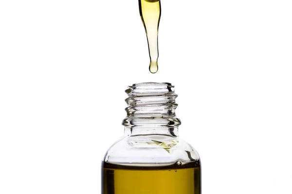 Massage oil in a glass bottle with a pipette on a white isolated background. — Stock Photo, Image