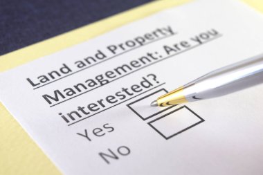 Bir kişi arazi ve emlak yönetimi ile ilgili soruları yanıtlıyor.