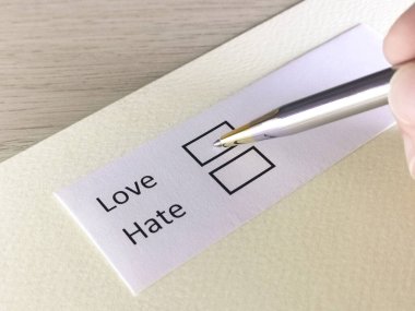 Bir kişi bir kağıt parçasındaki soruya cevap veriyor. İnsan aşkı ya da nefreti seçmeyi düşünüyor..