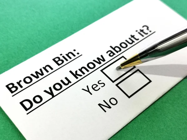 One person is answering question about brown bin.