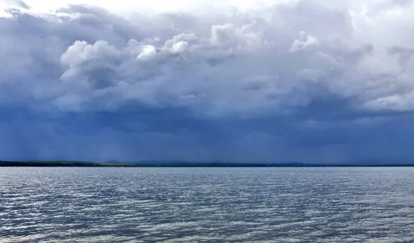 dark blue sky over the lake before the storm, dramatic lighting