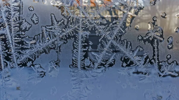 lines, frosty patterns on the window glass, texture of frosty patterns winter background