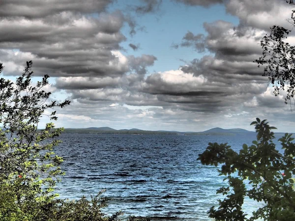 Awan abu-abu tebal di atas danau di malam hari mendung — Stok Foto