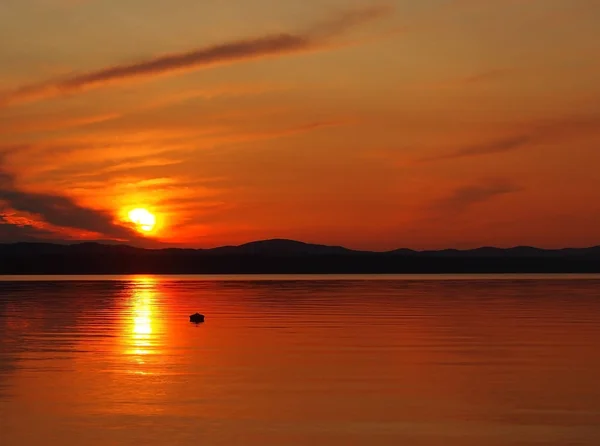 orange sunset sky and sun over the lake, Golden hour