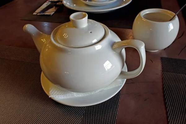 Teapot with tea on the table prepared for morning tea — Stock Photo, Image