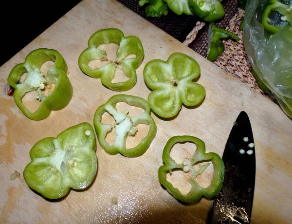 pieces of green bell pepper on the kitchen Board cut for salad