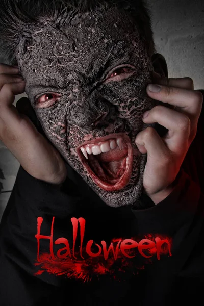 Scary screaming guy with fangs and red eyes at night. Inscription Halloween