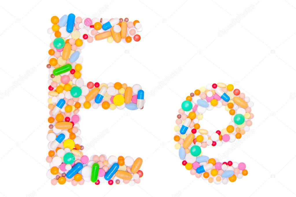 Letter E, English alphabet, made, collected from medical tablets, pills, capsules, vitamin. Isolated on white background. Concept: ABC, design, logo, title, text, word
