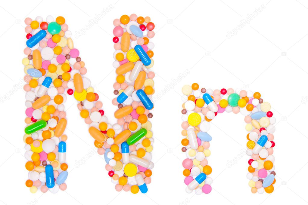 Letter N, English alphabet, made, collected from medical tablets, pills, capsules, vitamin. Isolated on white background. Concept: ABC, design, logo, title, text, word