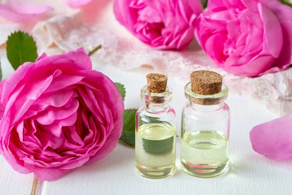Two Bottles Essential Oil Fresh Roses White Background — Stock Photo, Image