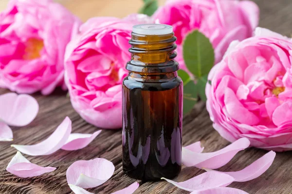 Bottle Essential Oil Roses Wooden Background — Stock Photo, Image