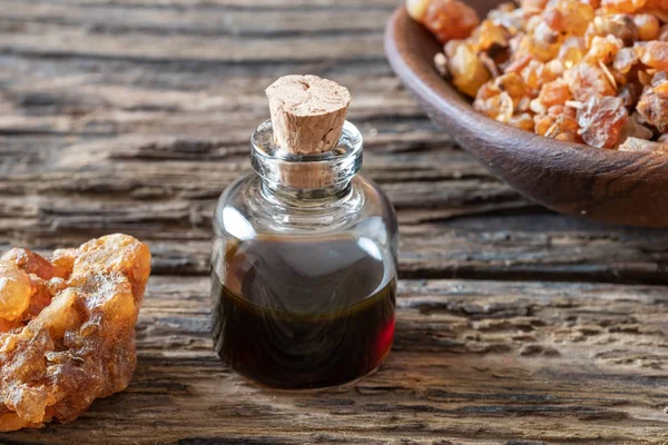 A bottle of myrrh essential oil with myrrh resin — Stock Photo, Image