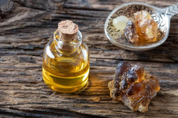 A bottle of frankincense essential oil with frankincense resin — Stock Photo, Image