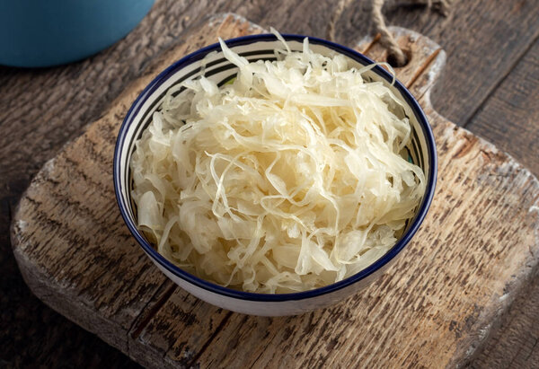 A bowl of fermented cabbage on a table