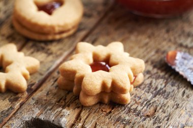 Star shaped homemade Linzer Christmas cookie filled with strawberry marmalade, closeup