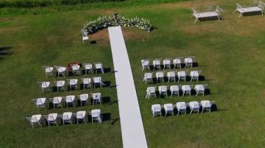 Wedding ceremony setup with chairs and floral arch