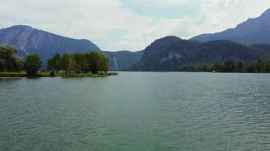 Scenic lake view with green peninsula and mountain peaks