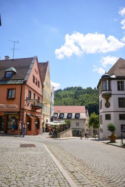 Street view with colorful houses and people in Fussen Bavaria Germany on June 28 2025 Editorial use only