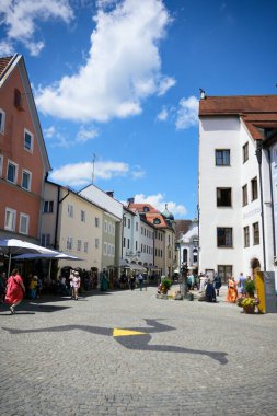 Fussen, Bavaria, Germany June 28, 2025: People walking along a cobblestone street in the historic old town with traditional German architecture on a sunny day.