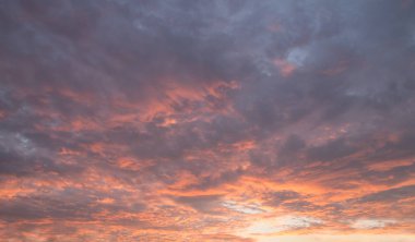Bir fırtına öncesi akşam günbatımı gökyüzü. Gri bulutlar güzel altın ve turuncu ışıklar gösterir.