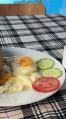 Kahvaltıda çırpılmış yumurta, ekmek tostu, domates ve fasulye. Üst Manzara. Lezzetli kahvaltı yemekleri. Vietnam banme bun banh mi