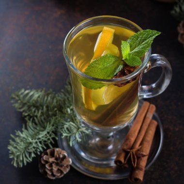 Kış Noel içki. Zencefil, karanfil, tarçın ve portakal dilimleri ile baharatlı narenciye sıcak çay. Koyu arka plan tablo tatil şenlikli dekorasyonu ile ısınma ve sağlıklı yumruk.